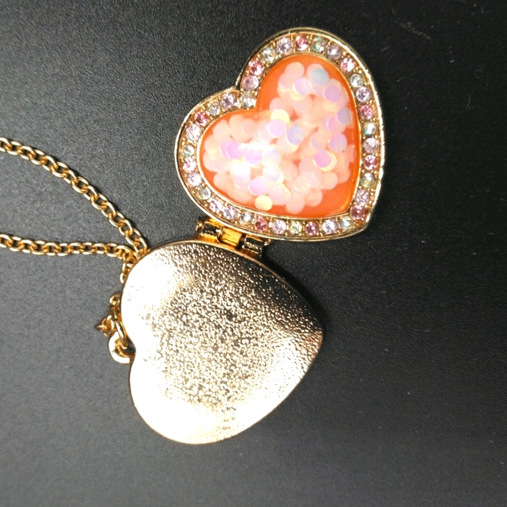 Adorable gold toned pink heart locket necklace